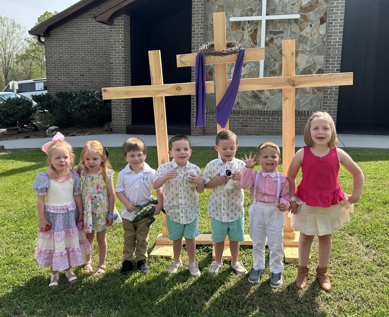 Ebenezer children gathered in front of three crosses at church